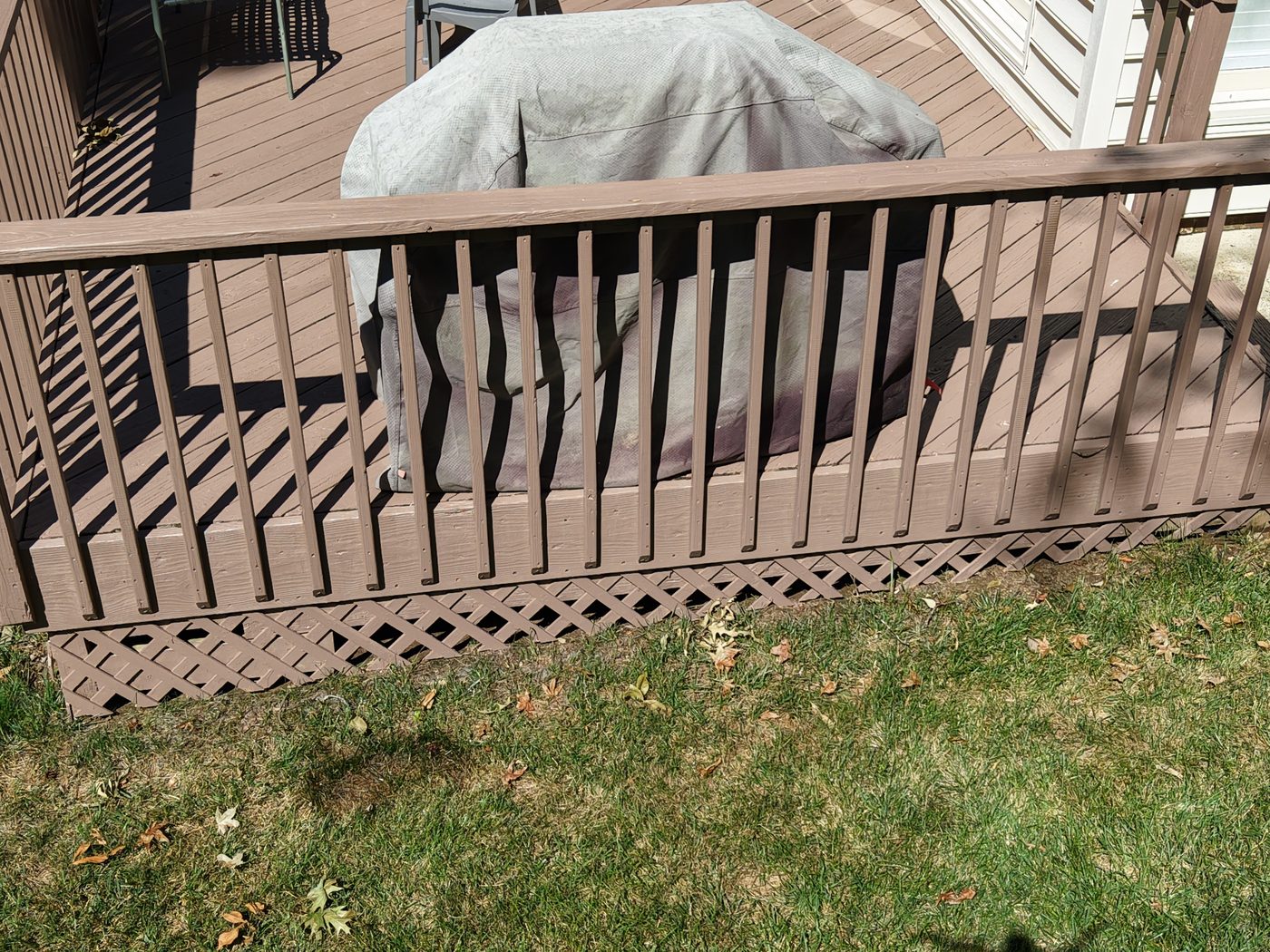 Close-up of a refinished wood deck railing and lattice in Charlotte, NC