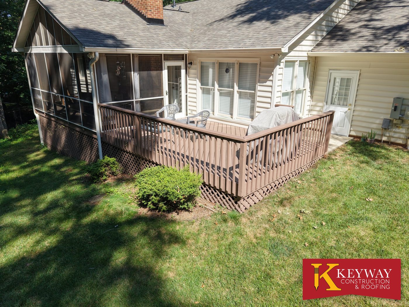 Stained wood deck with railing and screened porch repaired by Keyway Construction in Charlotte, NC
