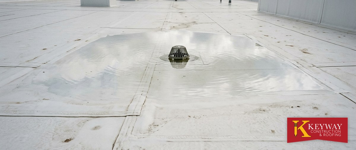 Ponding water around a roof drain on a Charlotte NC commercial flat roof