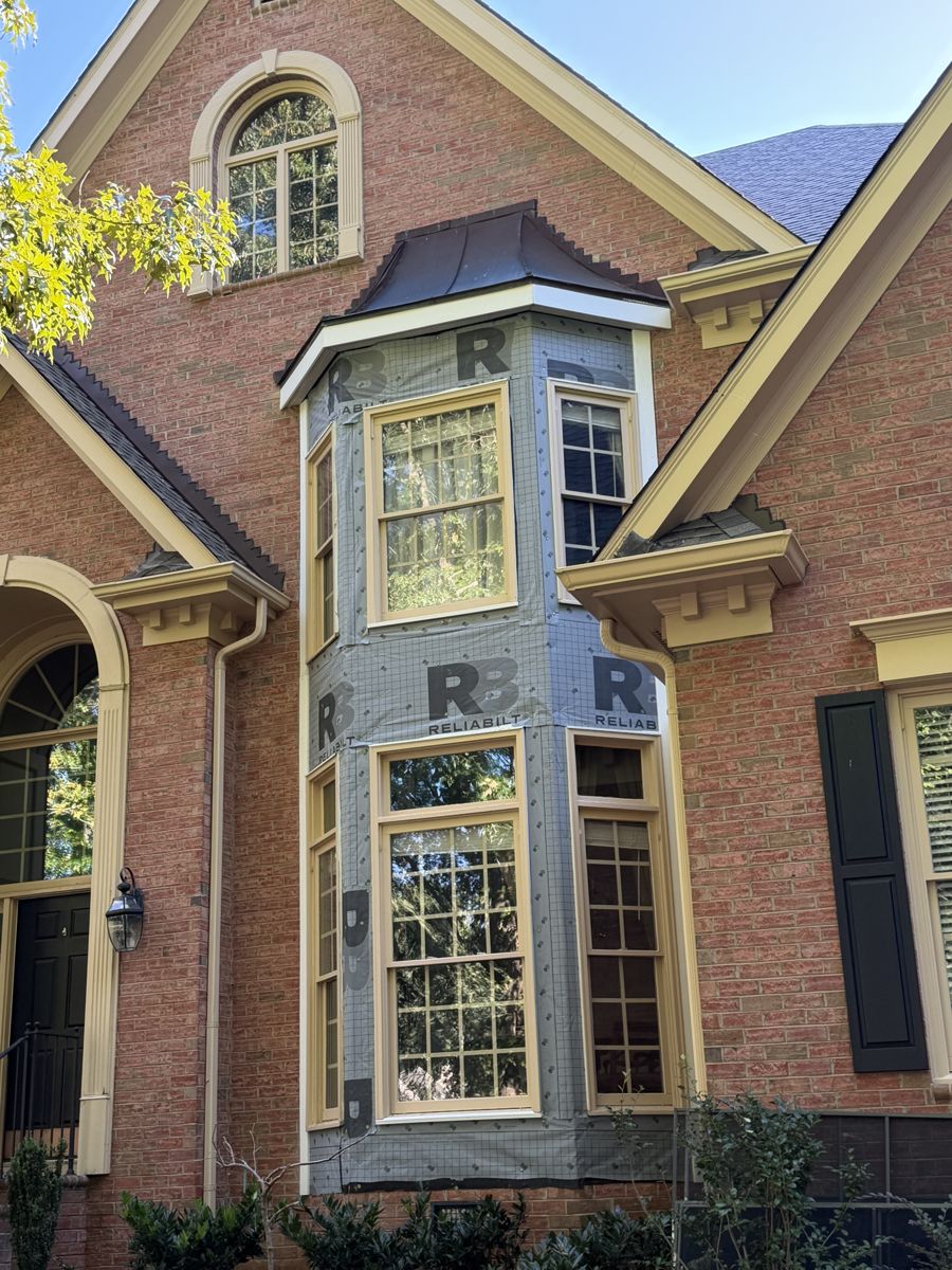 Bay window on a brick Charlotte home with the wall wrap exposed during a Keyway exterior repair