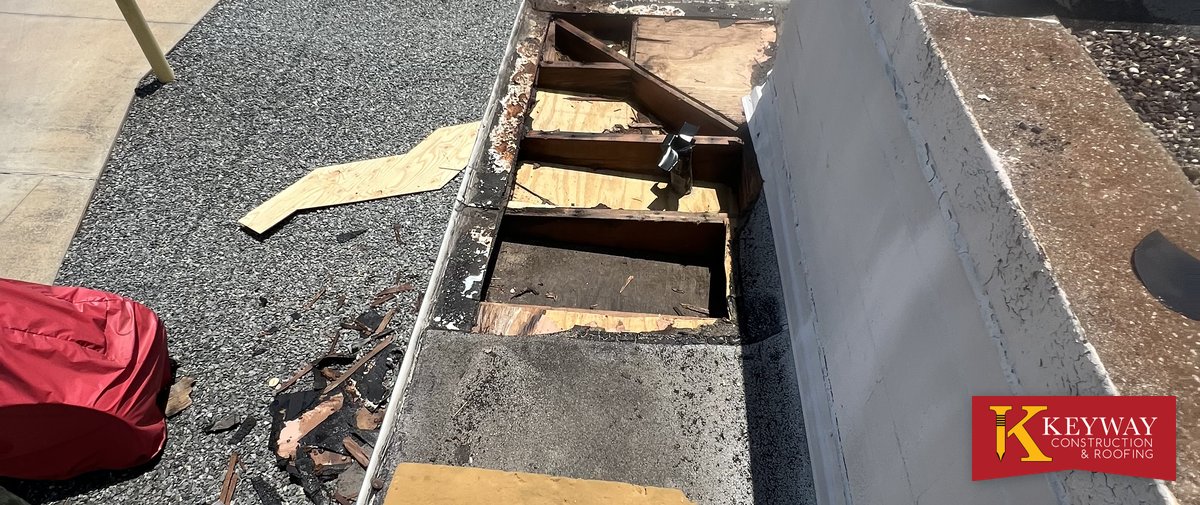 Commercial parapet wall opened to show rotted wood