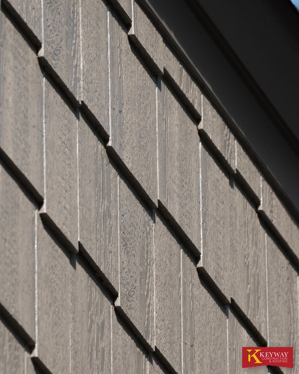 Shake style siding courses on a repaired dormer cheek wall