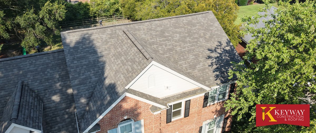 New charcoal architectural shingles on a two story brick home in Matthews NC