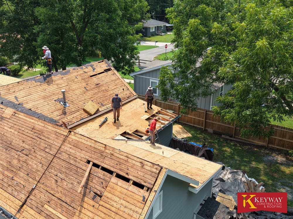 Keyway crew working on exposed board decking during a Monroe NC re-roof