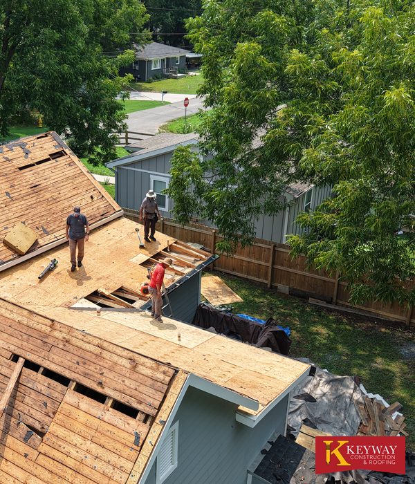 Keyway roofing crew replacing old plank board decking with new plywood on a Monroe NC home during a re-roof